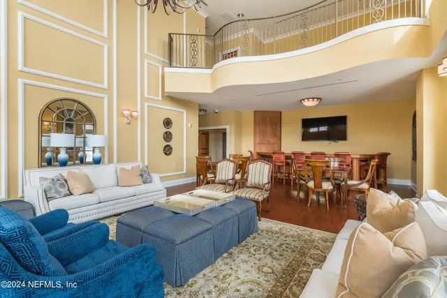 a living room with furniture potted plant and a large window