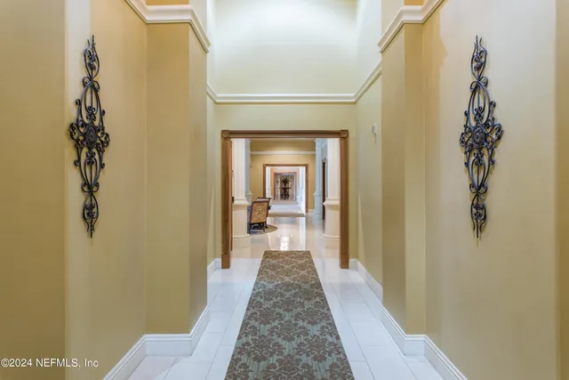 a hallway with a door and wooden floor