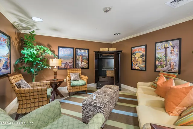 a living room with furniture fireplace and a large window
