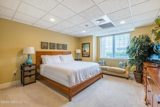 a spacious bedroom with a bed and a couch