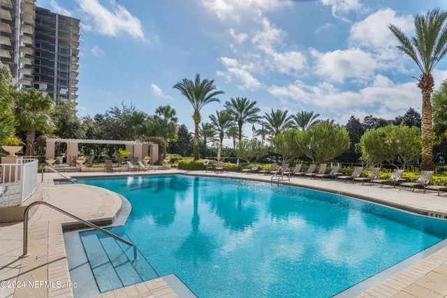a view of swimming pool with outdoor seating and plants