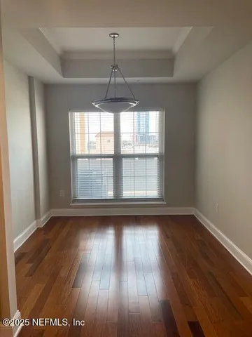 a room with wooden floor and furniture