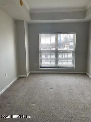 a view of a hallway with a livingroom and a bathroom with sink