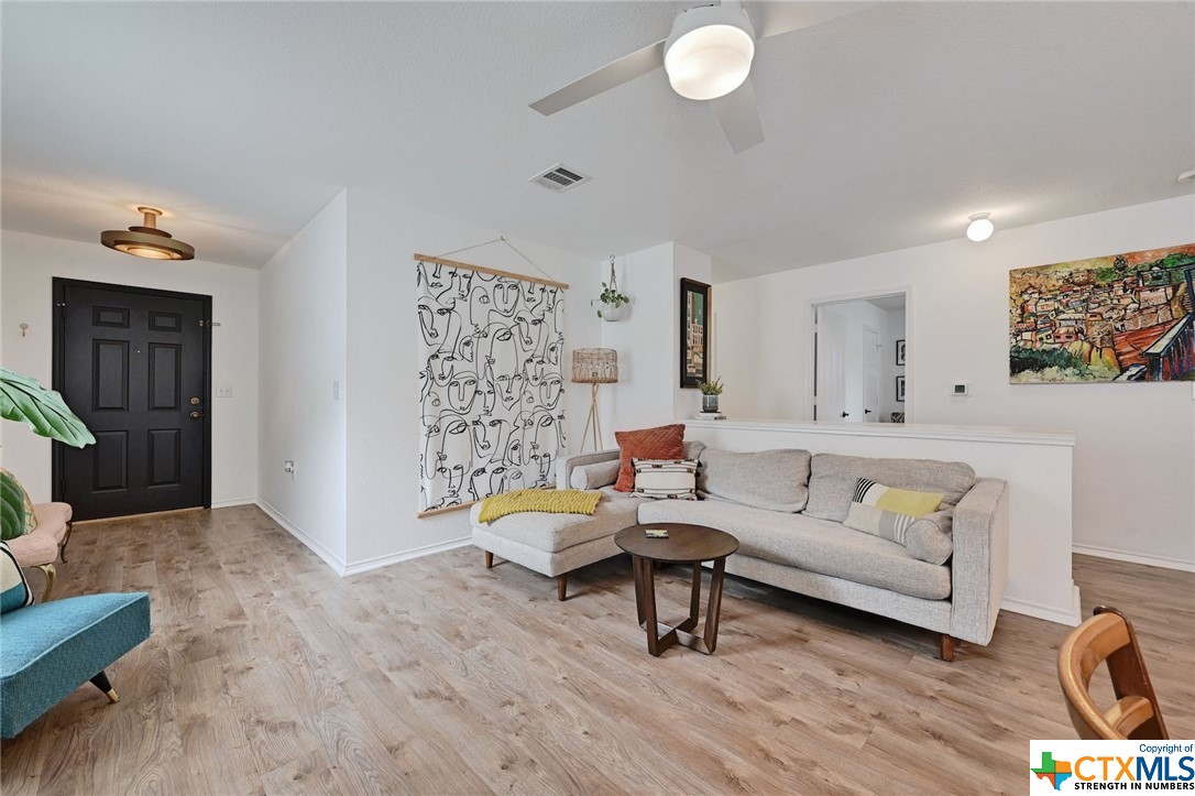 6620 Doyal Drive Austin, TX 78747 - Photo 1 of 1 a living room with furniture and wooden floor