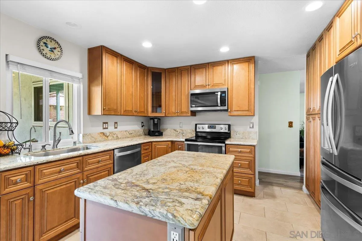 10738 2nd Street Santee, CA 92071 - Photo 10 of 52 a kitchen with stainless steel appliances granite countertop a refrigerator stove top oven a sink and dishwasher