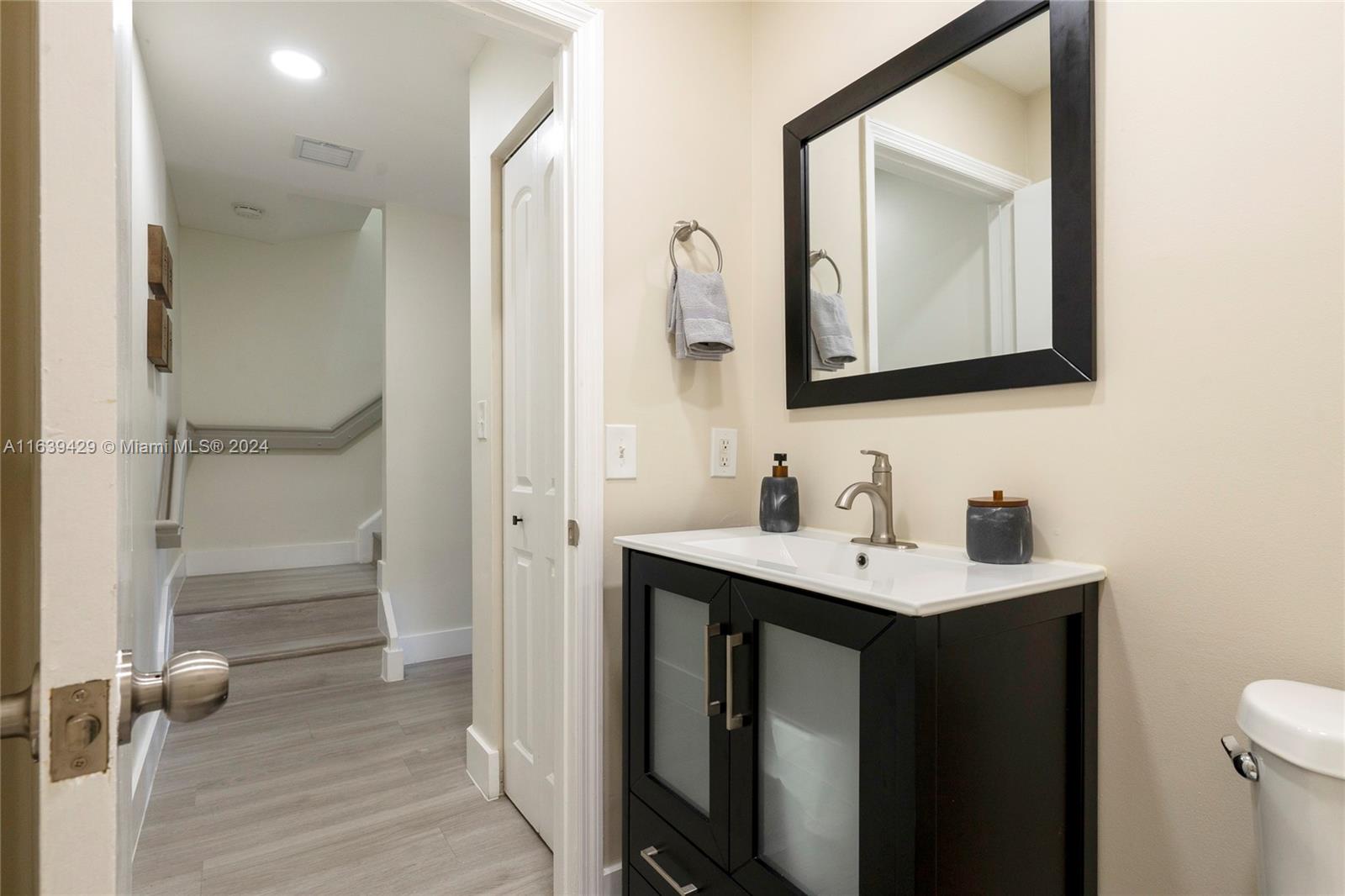 18606 Southwest 100th Avenue, Unit 18606 Cutler Bay, FL 33157 - Photo 14 of 29 a bathroom with a sink vanity and a mirror