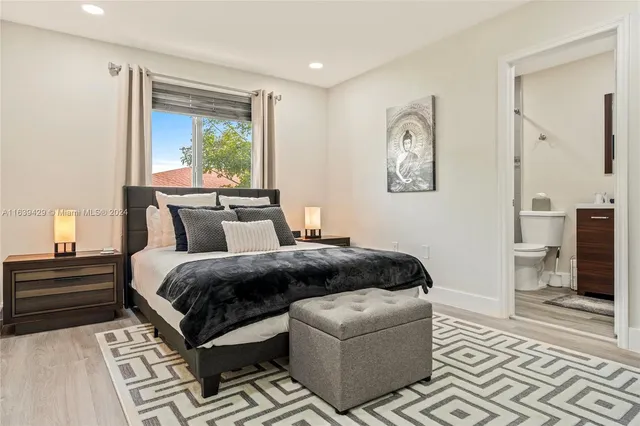 a bedroom with a large bed and a window