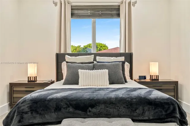 a bedroom with a bed and window