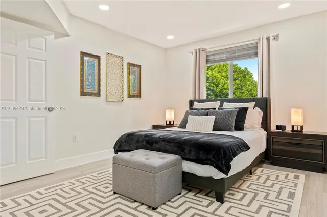 a bedroom with bed and window