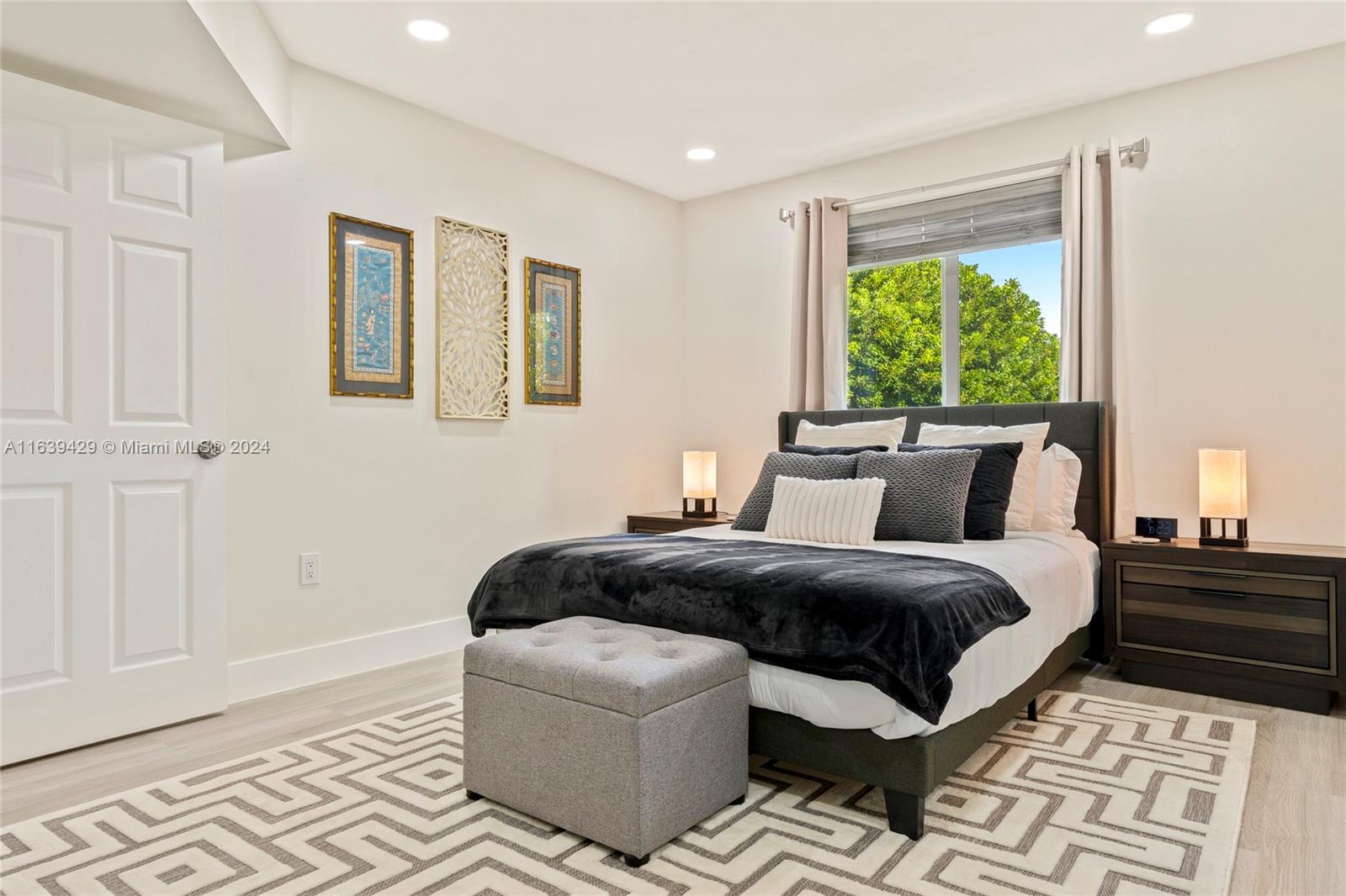 18606 Southwest 100th Avenue, Unit 18606 Cutler Bay, FL 33157 - Photo 18 of 29 a bedroom with bed and window