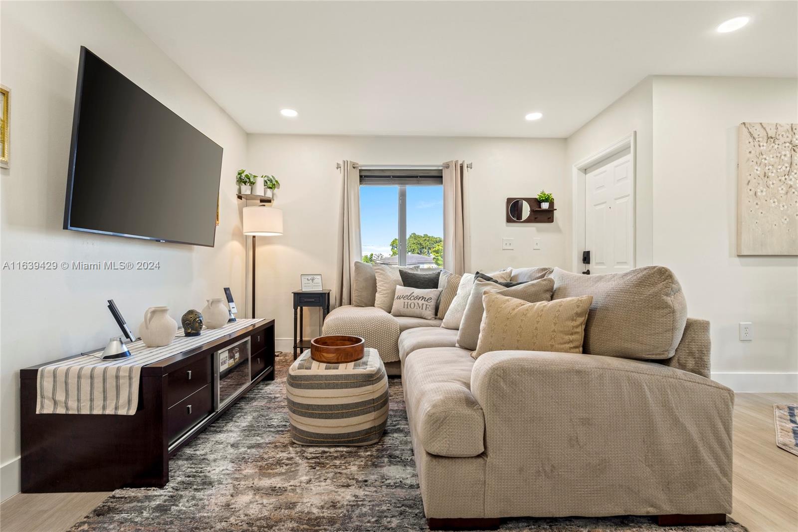 18606 Southwest 100th Avenue, Unit 18606 Cutler Bay, FL 33157 - Photo 2 of 29 a living room with furniture and a flat screen tv