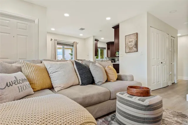a living room with furniture and a lamp