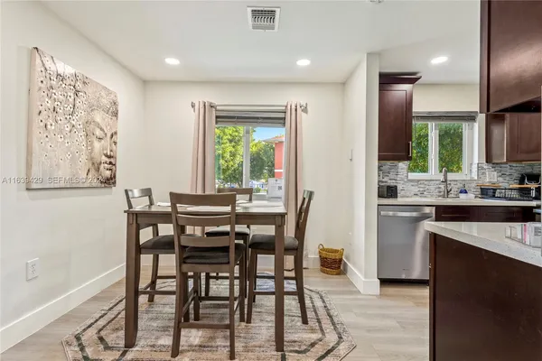 a view of a dining room with furniture and a window