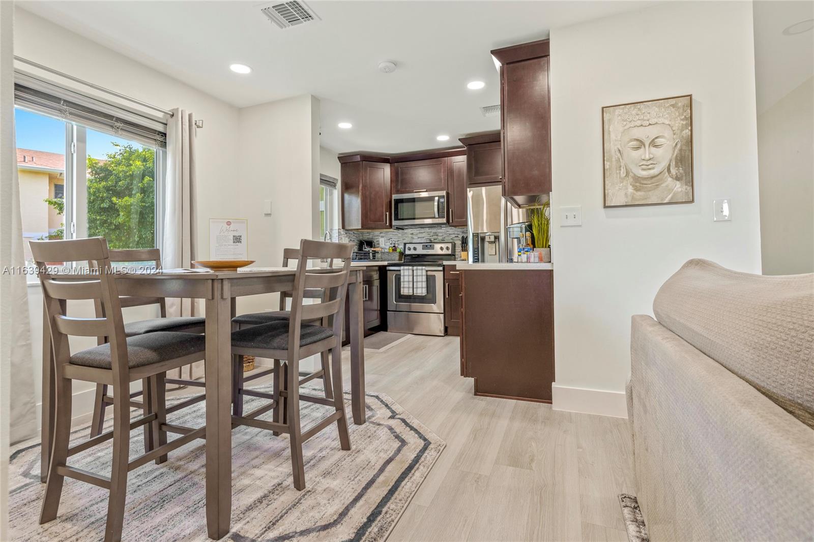 18606 Southwest 100th Avenue, Unit 18606 Cutler Bay, FL 33157 - Photo 6 of 29 a view of a dining room with furniture window and outside view