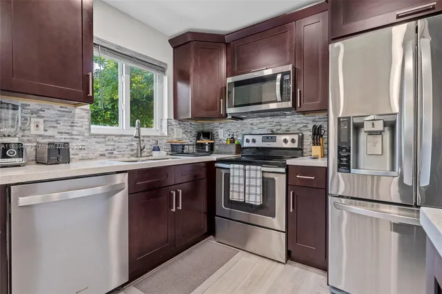 a kitchen with a sink stove and microwave