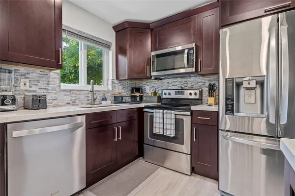 a kitchen with a sink stove and microwave