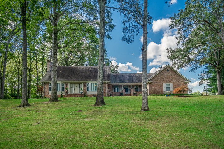 88 Lakeland Drive McMinnville, TN 37110 - Photo 1 of 41 a view of a house with a big yard and large trees