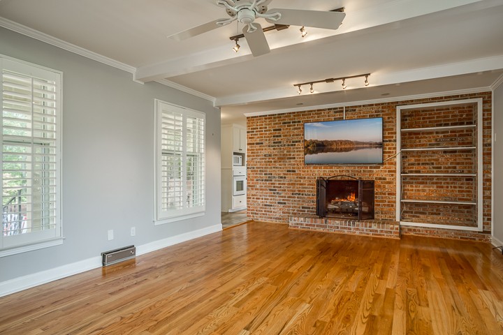 88 Lakeland Drive McMinnville, TN 37110 - Photo 21 of 41 a view of an empty room with wooden floor fireplace and a window
