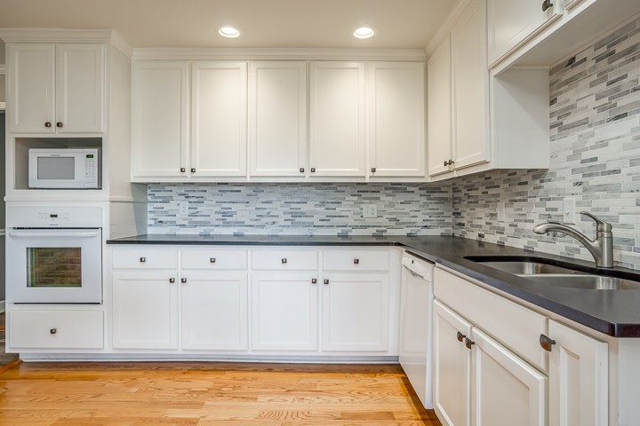 88 Lakeland Drive McMinnville, TN 37110 - Photo 24 of 41 a kitchen with granite countertop white cabinets and stainless steel appliances