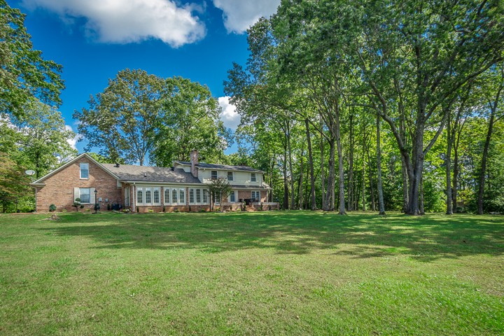 88 Lakeland Drive McMinnville, TN 37110 - Photo 6 of 41 a view of a house with a big yard and large trees