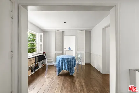 a kitchen with a table chairs and a window