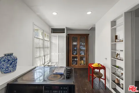 a view of a kitchen with fridge and workspace