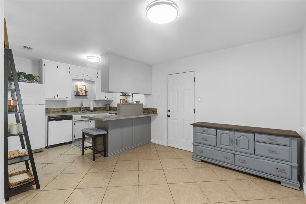 708 East Prairie View Road Crowley, TX 76036 - Photo 6 of 21 Kitchen featuring white cabinetry, a gray island with a countertop, an electric range, and a dishwasher