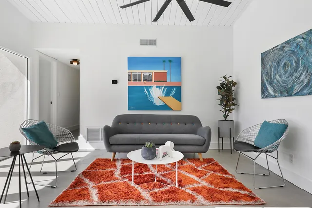 a living room with furniture and a rug