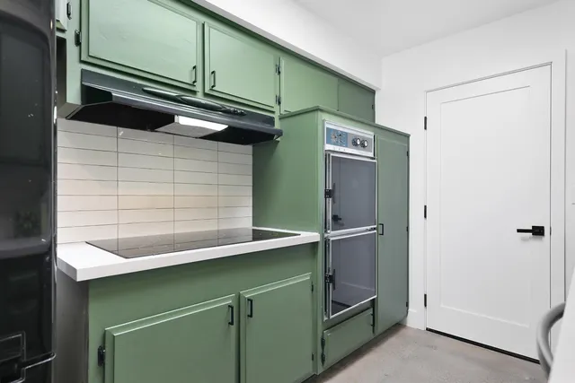 a kitchen with a refrigerator and a sink