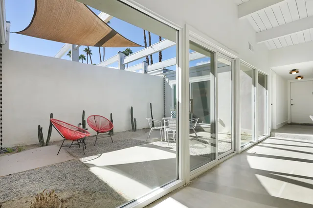 a dining room with furniture a table and chairs