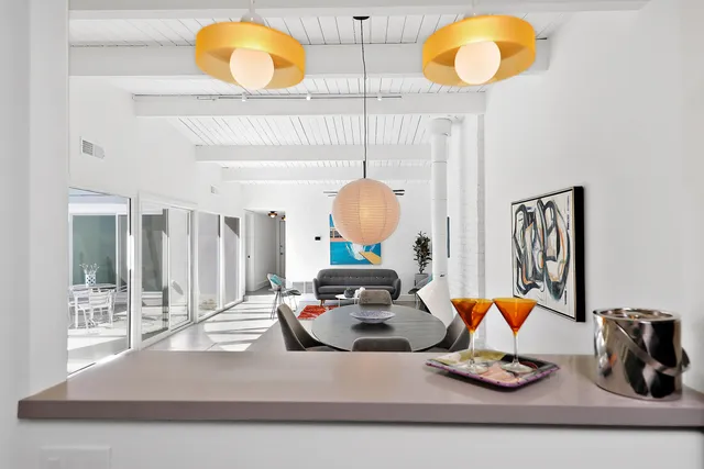 a living room with dining room and wooden floor