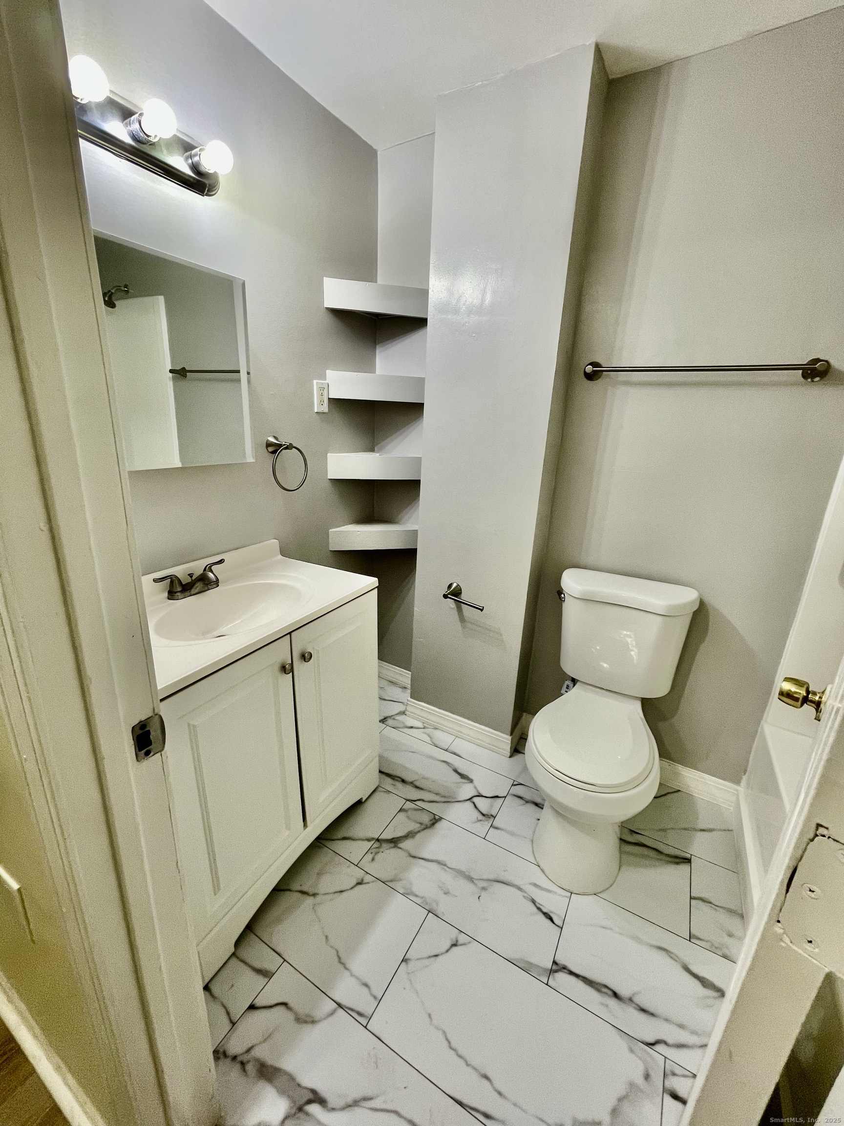 92 West Main Street, Unit 1 Vernon, CT 06066 - Photo 4 of 5 a bathroom with a sink a toilet a vanity and a shower