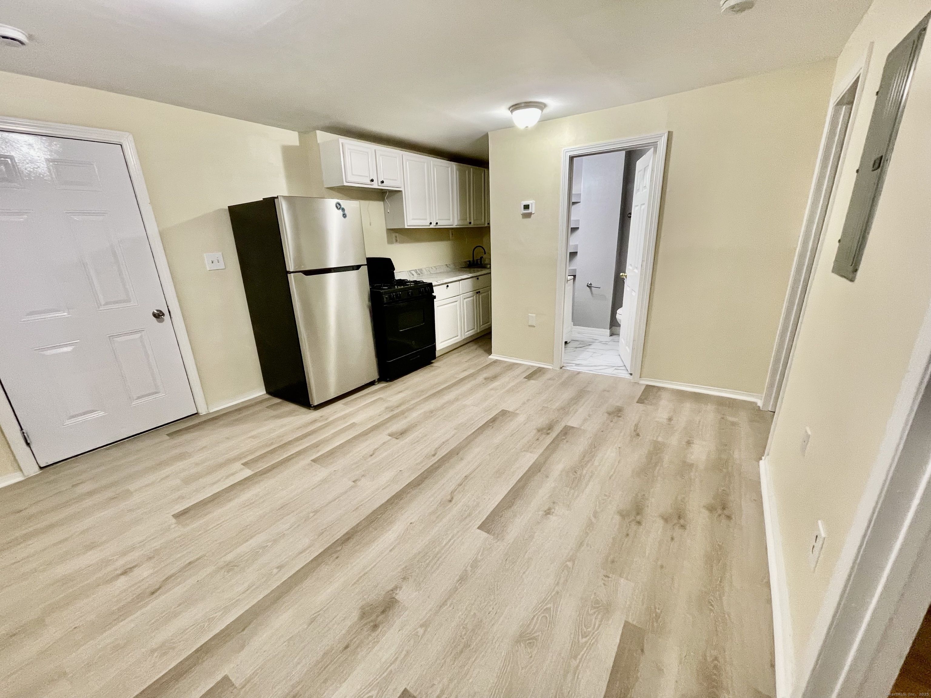92 West Main Street, Unit 1 Vernon, CT 06066 - Photo 5 of 5 a view of kitchen with refrigerator stove and wooden floor
