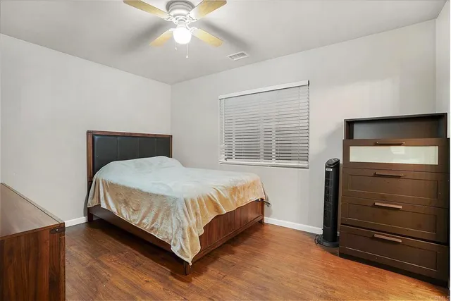 a bathroom with a granite countertop sink mirror and a toilet