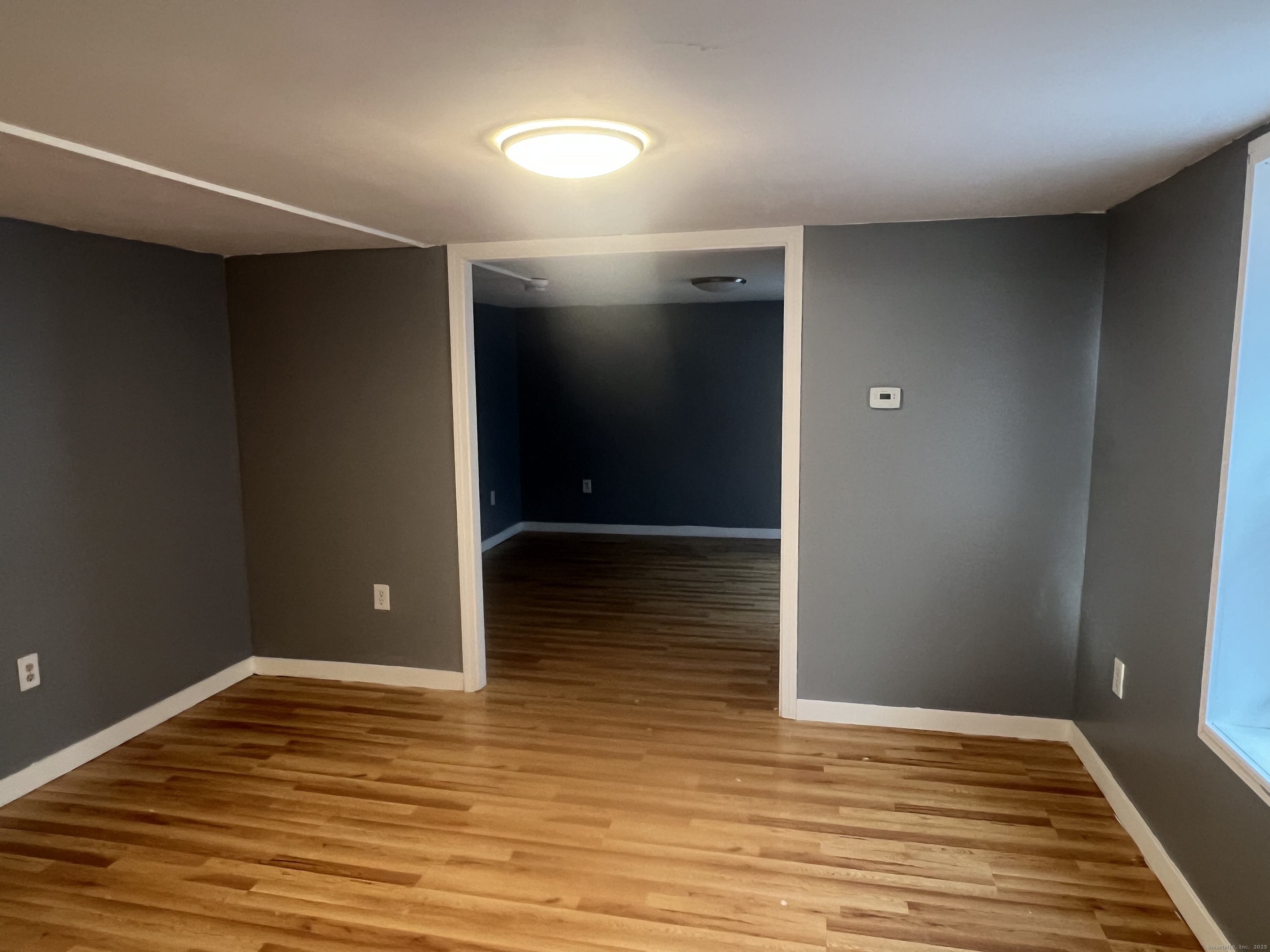 83 Litchfield Street Thomaston, CT 06787 - Photo 13 of 24 wooden floor in an empty room