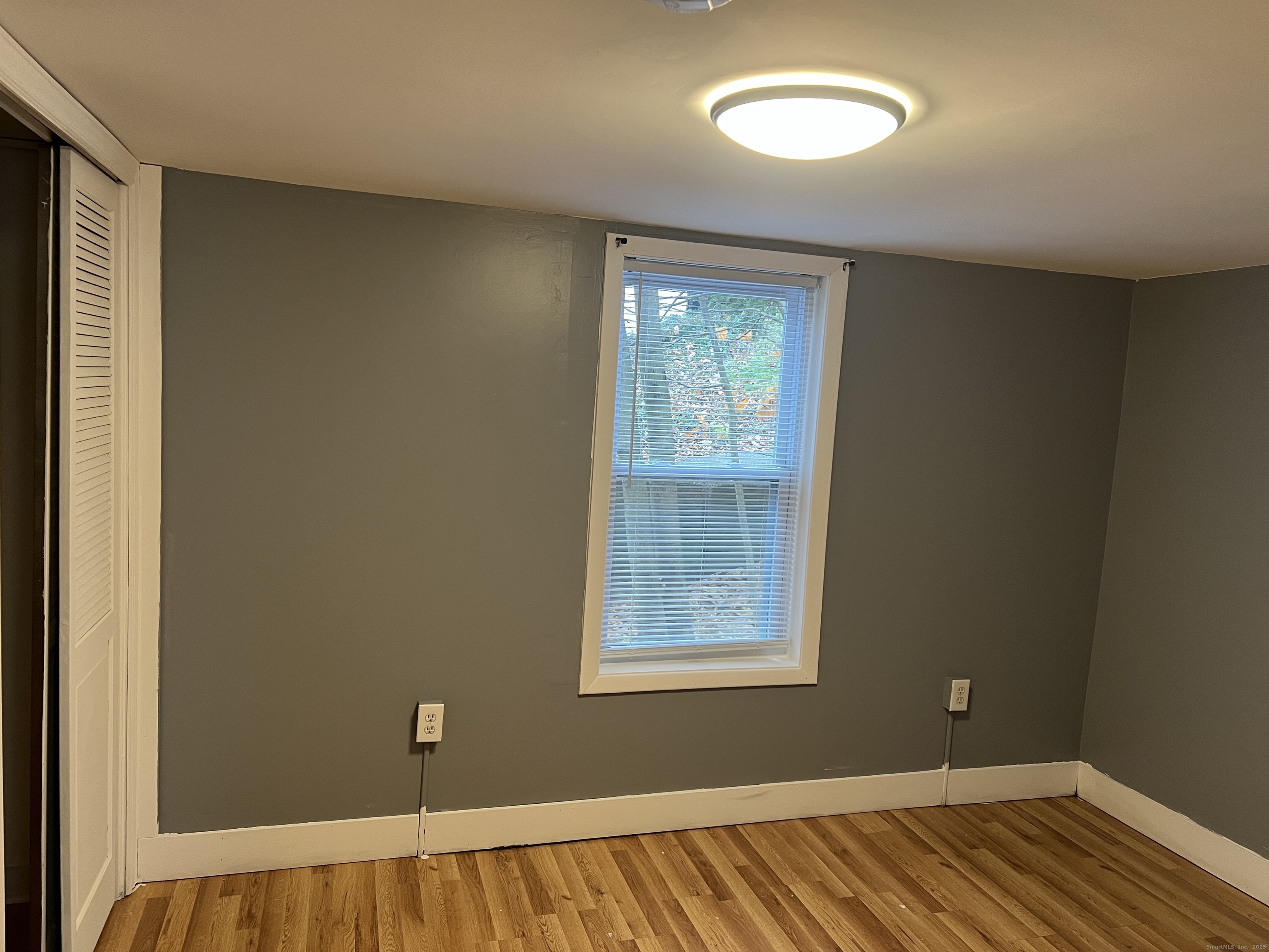 83 Litchfield Street Thomaston, CT 06787 - Photo 23 of 24 a view of a room with wooden floor and windows