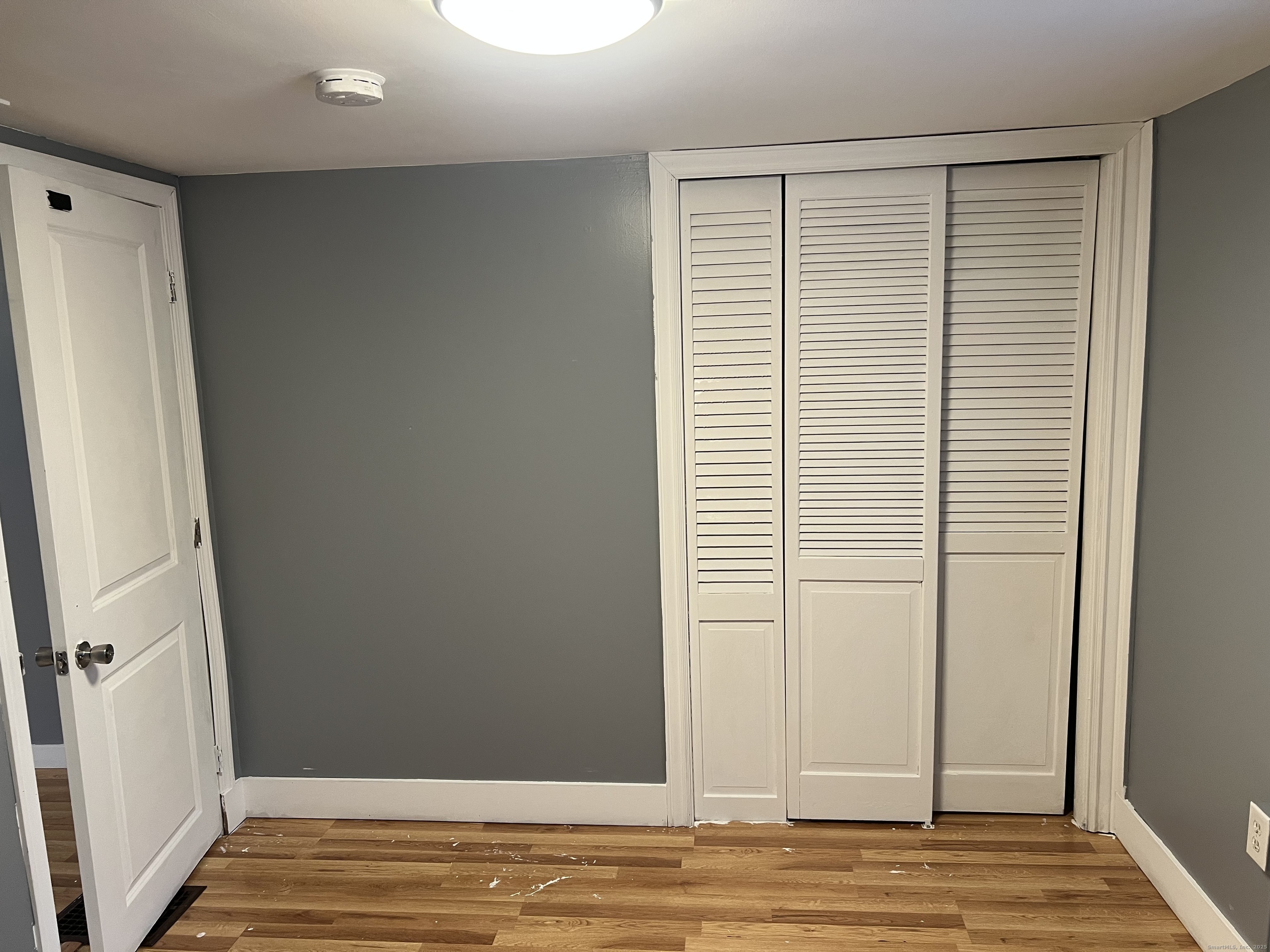 83 Litchfield Street Thomaston, CT 06787 - Photo 24 of 24 an empty room with wooden floor and entrance