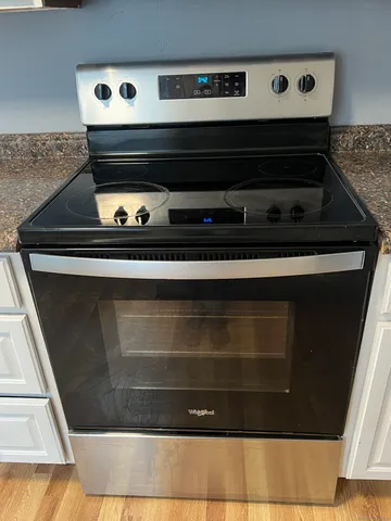a stove top oven sitting inside of a kitchen