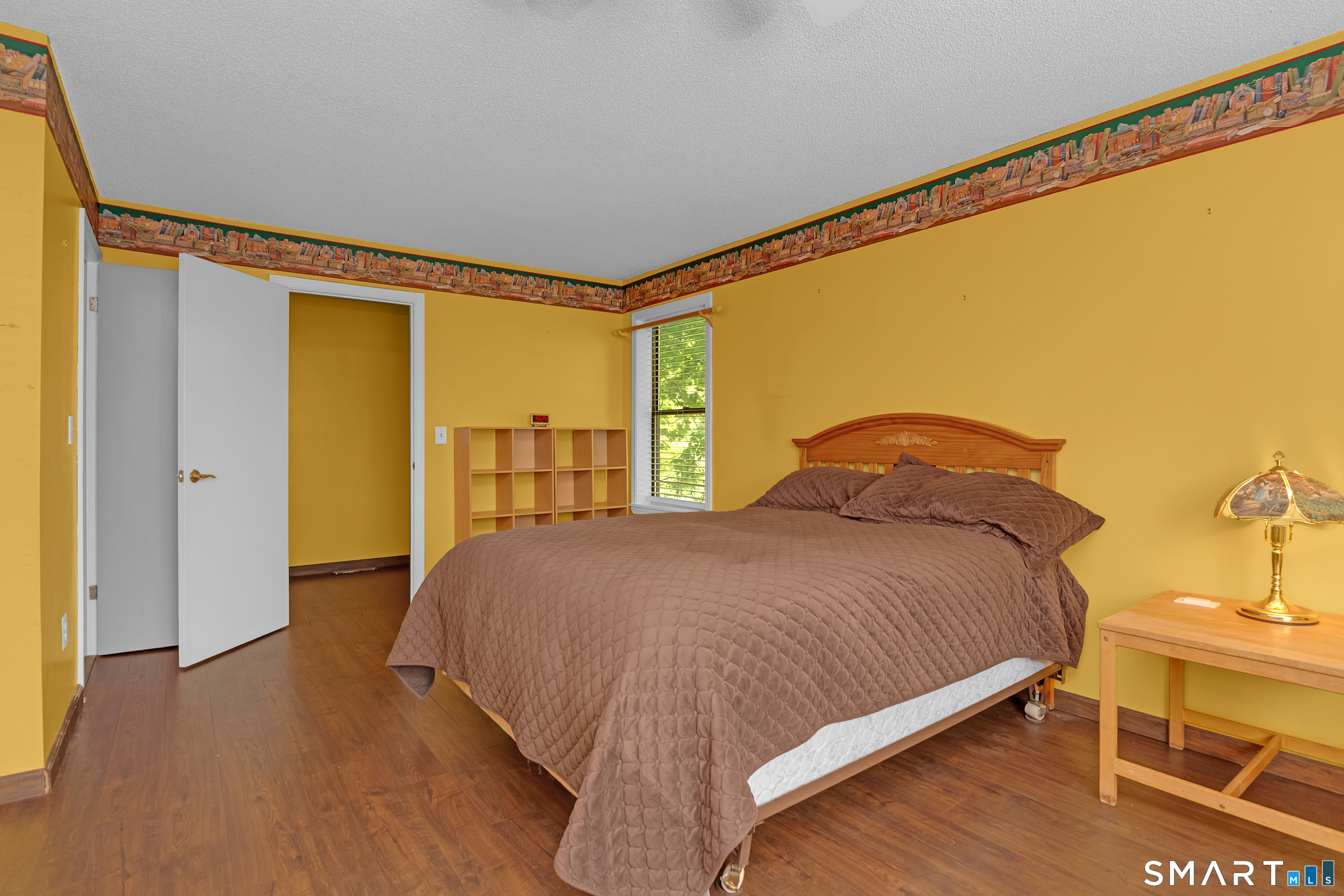 90 Bell Street Manchester, CT 06040 - Photo 20 of 40 a bedroom with a bed and wooden floor