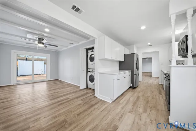 a view of kitchen with refrigerator microwave and stove