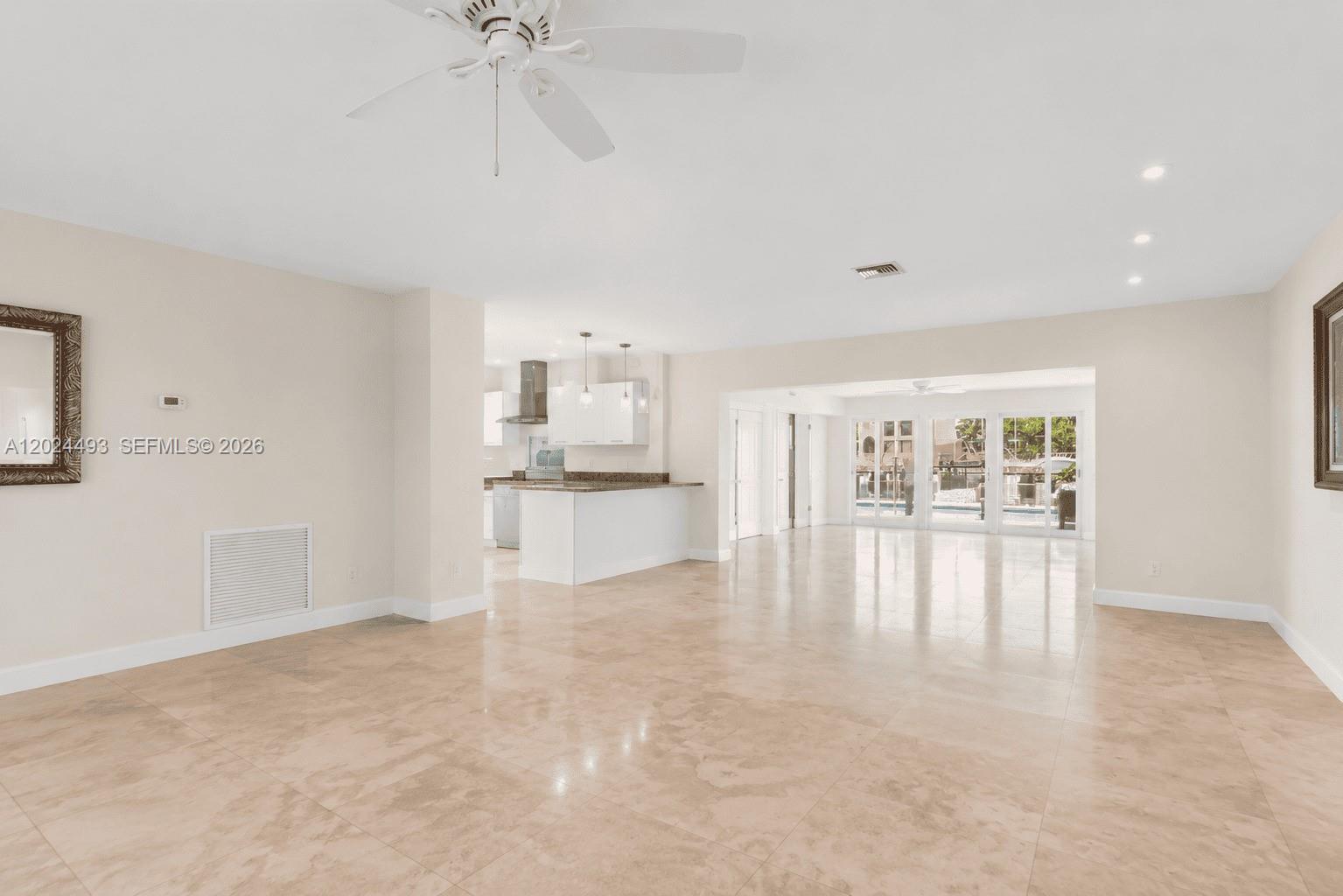 1995 Ixora Road North Miami, FL 33181 - Photo 2 of 23 a view of empty room with kitchen view