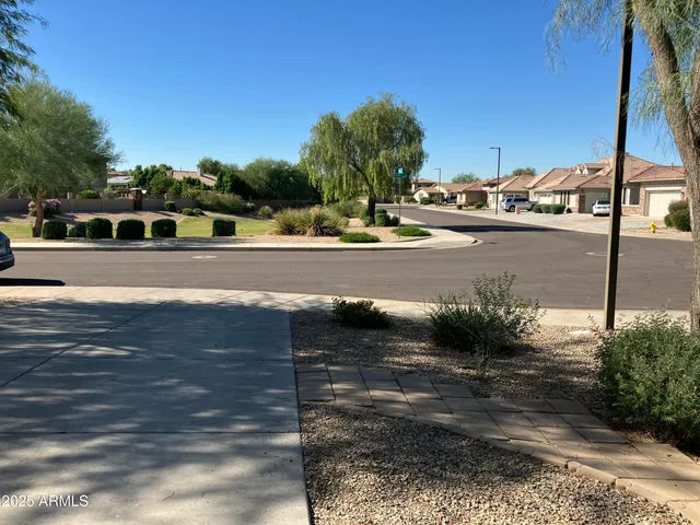 a kitchen with kitchen island granite countertop a sink stove and refrigerator