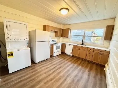 a kitchen with a sink a refrigerator and window