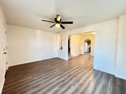 a view of empty room with wooden floor