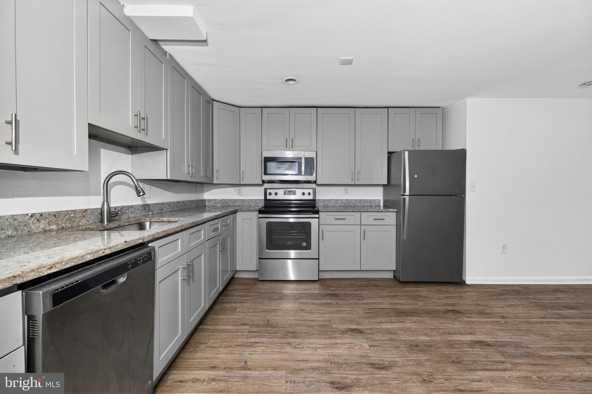 4636 Hillside Road Southeast Washington, DC 20019 - Photo 17 of 44 a kitchen with kitchen island a sink stainless steel appliances and cabinets