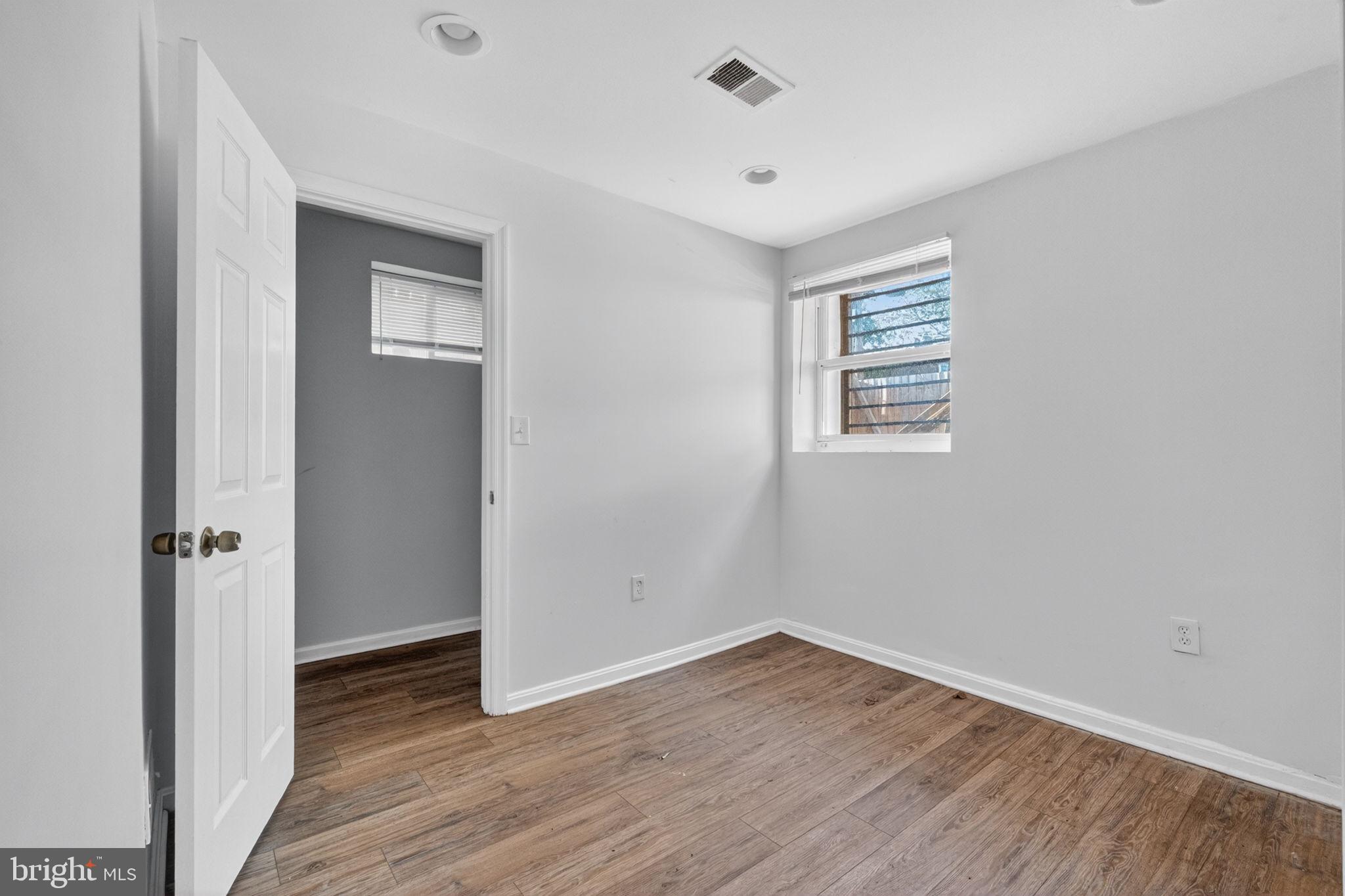 4636 Hillside Road Southeast Washington, DC 20019 - Photo 21 of 44 an empty room with wooden floor and windows