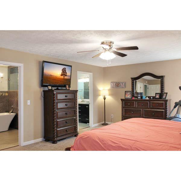 398 Strawberry Ridge Manchester, TN 37355 - Photo 9 of 30 a bedroom with a bed and a flat screen tv