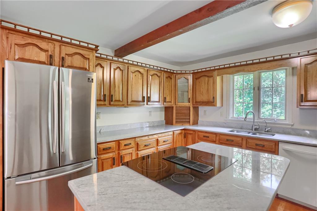 9650 Goehring Road Cranberry Township, PA 16066 - Photo 14 of 48 a kitchen with stainless steel appliances granite countertop a refrigerator and a sink