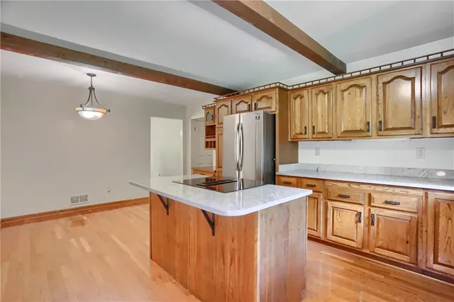 a kitchen with stainless steel appliances granite countertop a sink refrigerator and cabinets