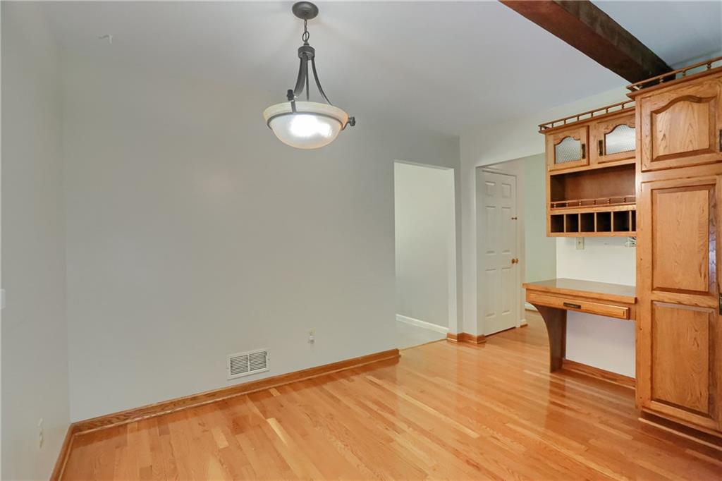 9650 Goehring Road Cranberry Township, PA 16066 - Photo 17 of 47 a view of an empty room with wooden floor and a window